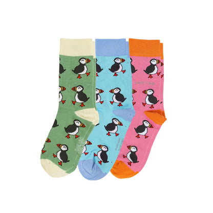 Set of three colorful socks with puffin patterns on a white background