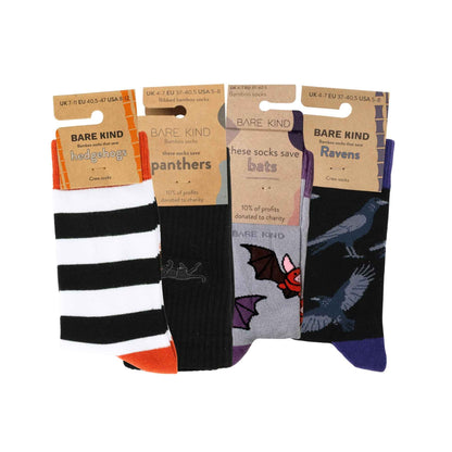 Four pairs of Bare Kind brand crew socks displayed side-by-side on their cardboard hangers against a white background.