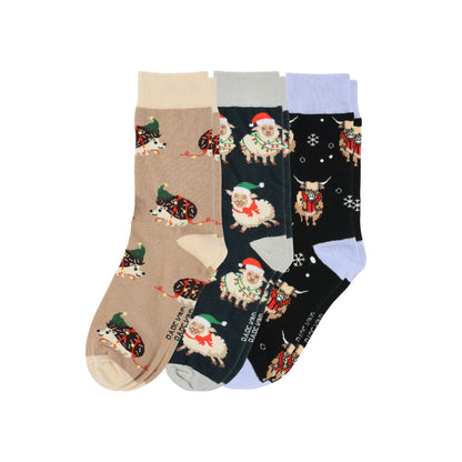 Set of four pairs of socks with festive animal patterns on a white background