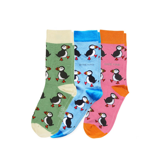 Set of three colorful socks with puffin patterns on a white background