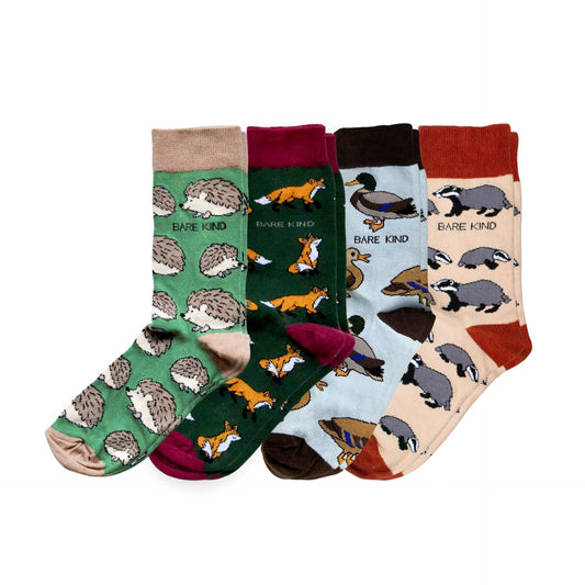 Set of four pairs of socks with animal patterns on a white background