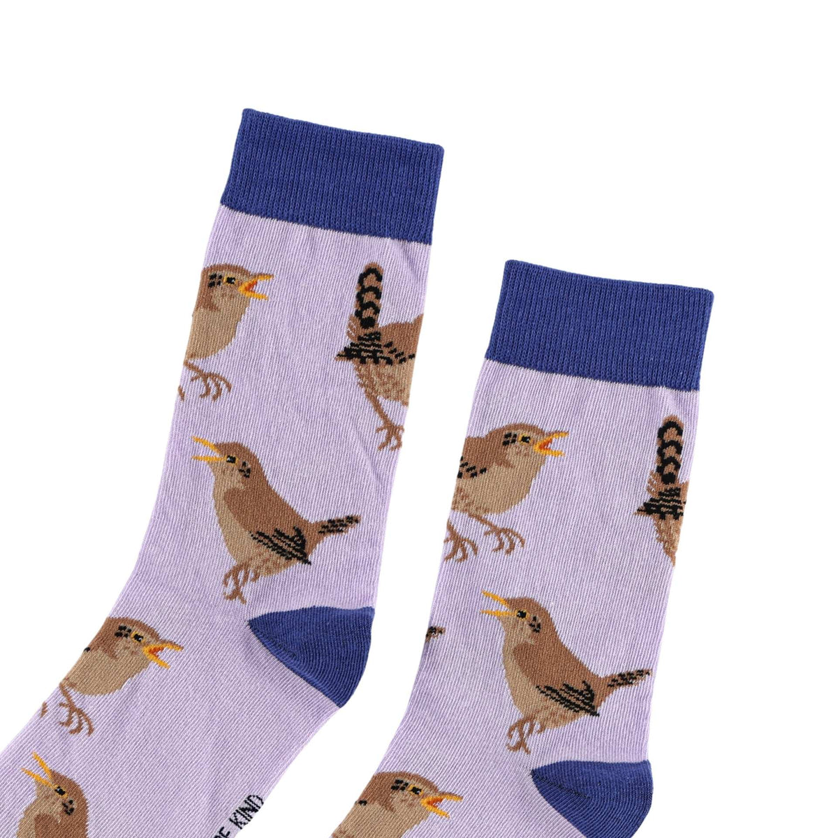 A pair of crew socks with a light lavender background featuring a repeating pattern of brown birds with yellow beaks. The socks have solid dark blue ribbed cuffs, heels, and toes, and are displayed against a plain white background.
