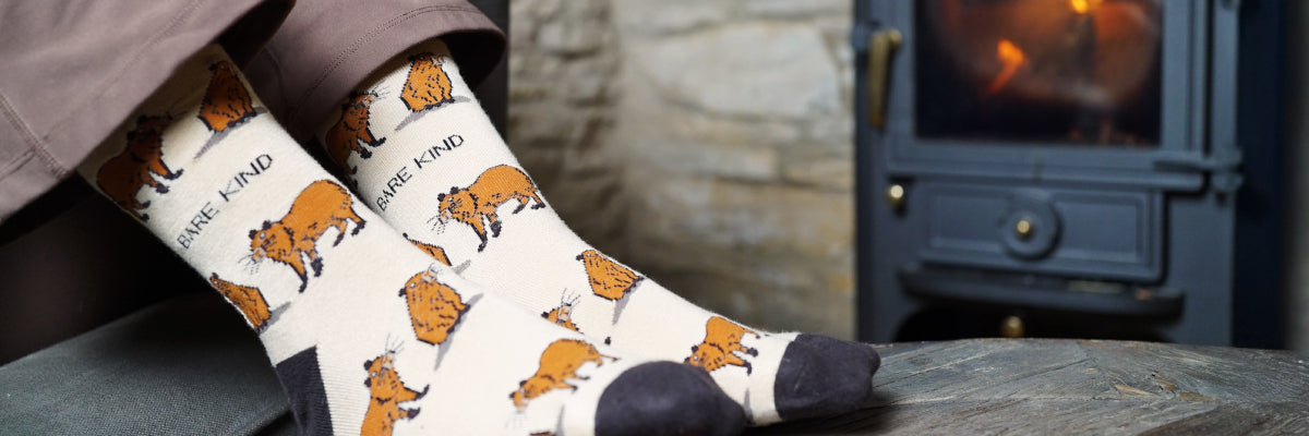 model wearing capybara bamboo socks in a cosy place