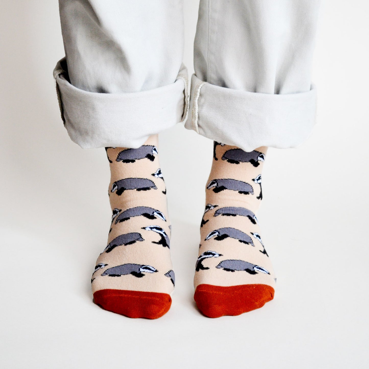 standing model wearing beige badger socks