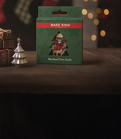 Bare Kind bamboo crew socks packaging on a wooden surface with festive decorations.