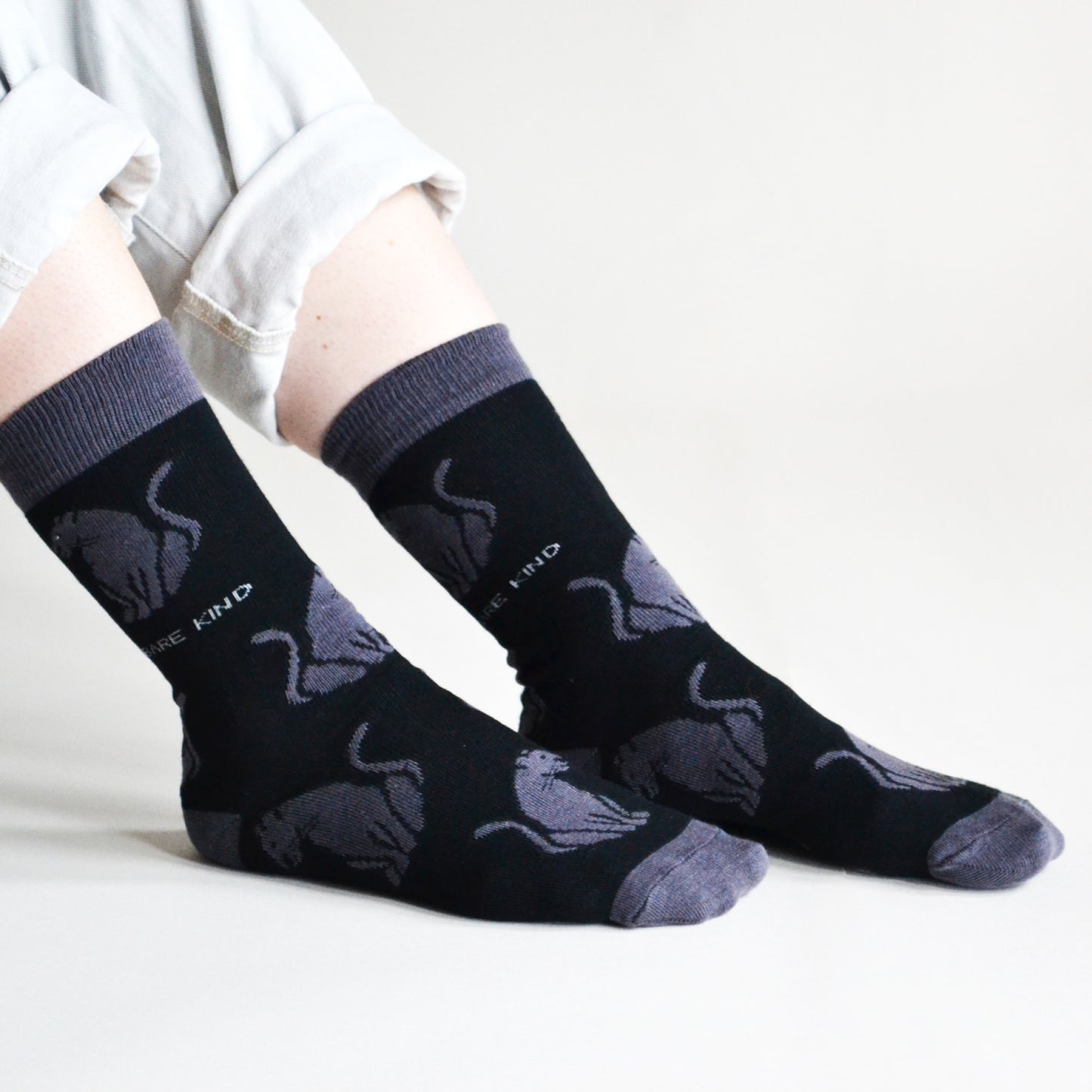 side angle view of model wearing black panther bamboo socks 