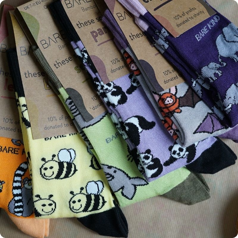Collection of colorful socks with animal patterns on a cardboard background