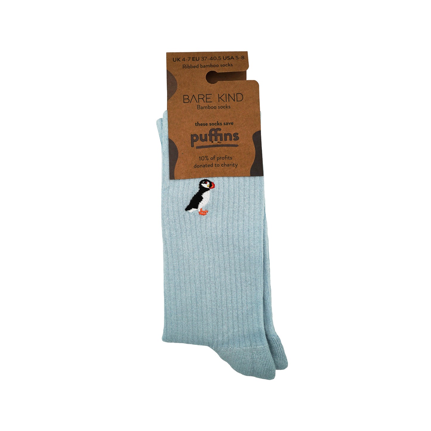 folded flat lay of pastel blue ribbed puffin bamboo socks in 100% recycled cardboard packaging