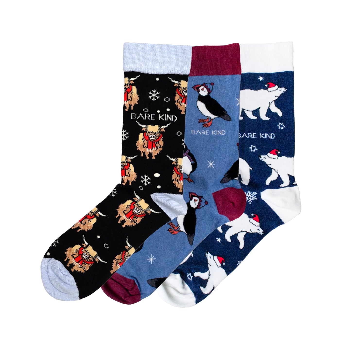 flat lay image of blue christmas bundle made up of christmas highland cow, puffin and polar bear bamboo socks