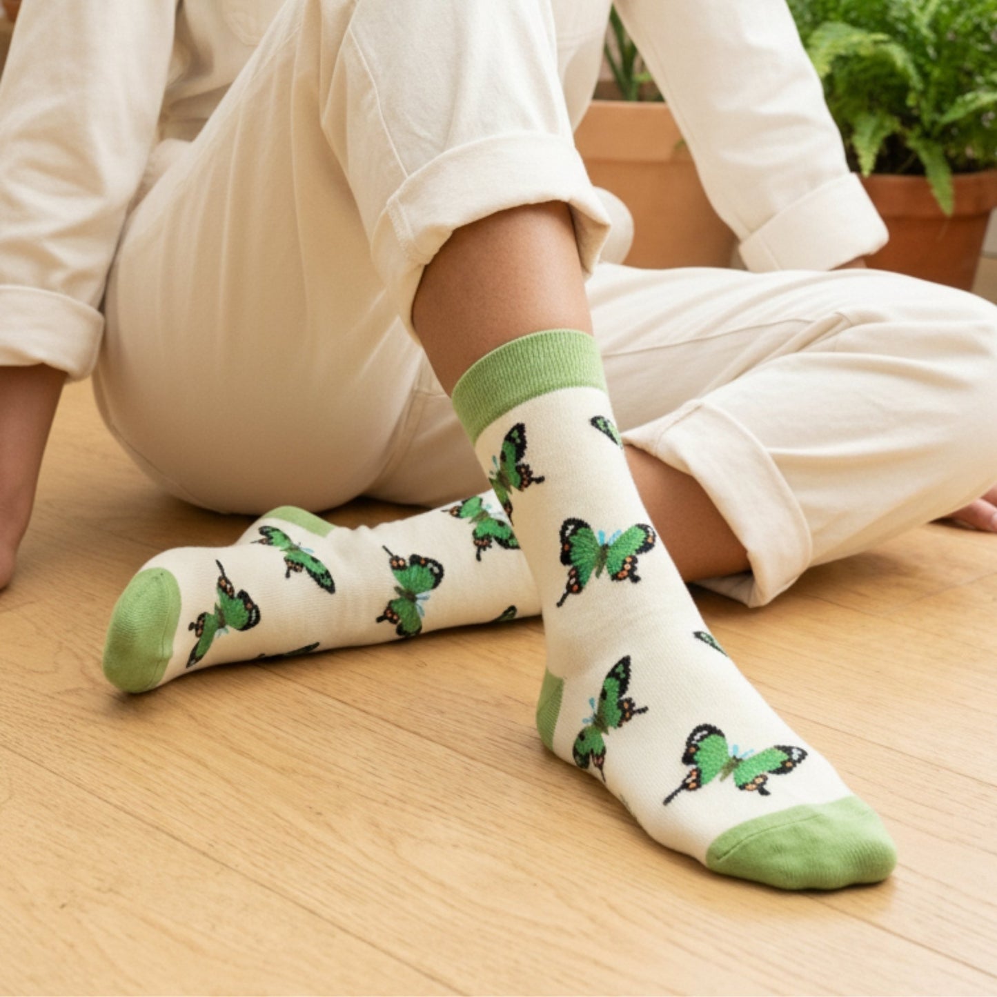 Model wearing green butterfly socks