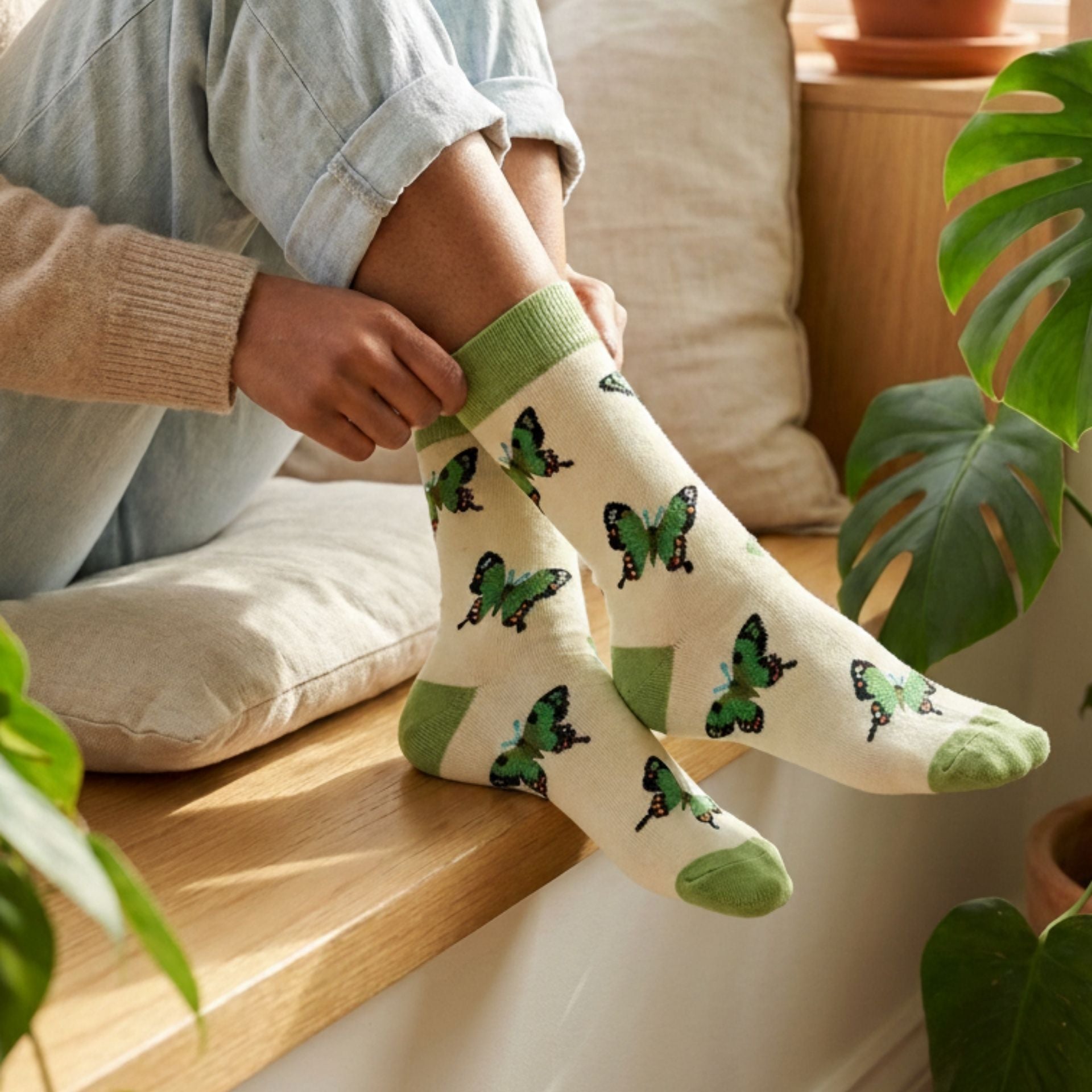 Model wearing green butterfly socks