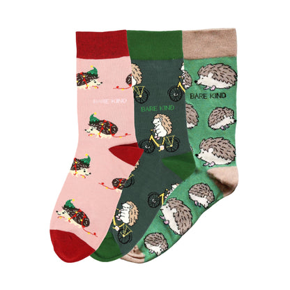 flat lays of pink christmas hedgehog, green hedgehog sport, green hedgehog bamboo socks