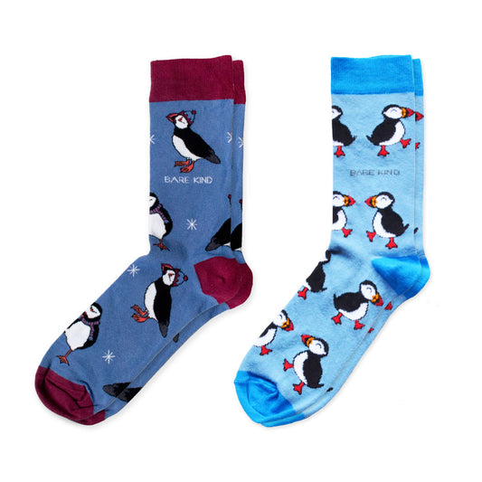 flat lay image of blue christmas puffin bamboo socks and blue puffin bamboo socks