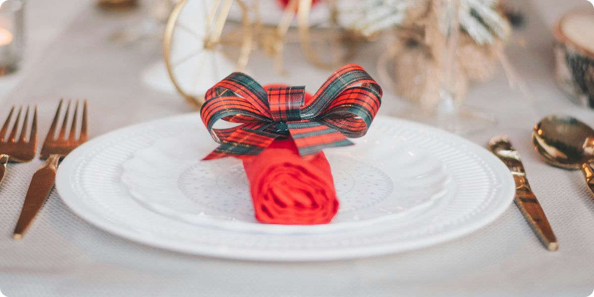 Christmas table, red napkin on the plate