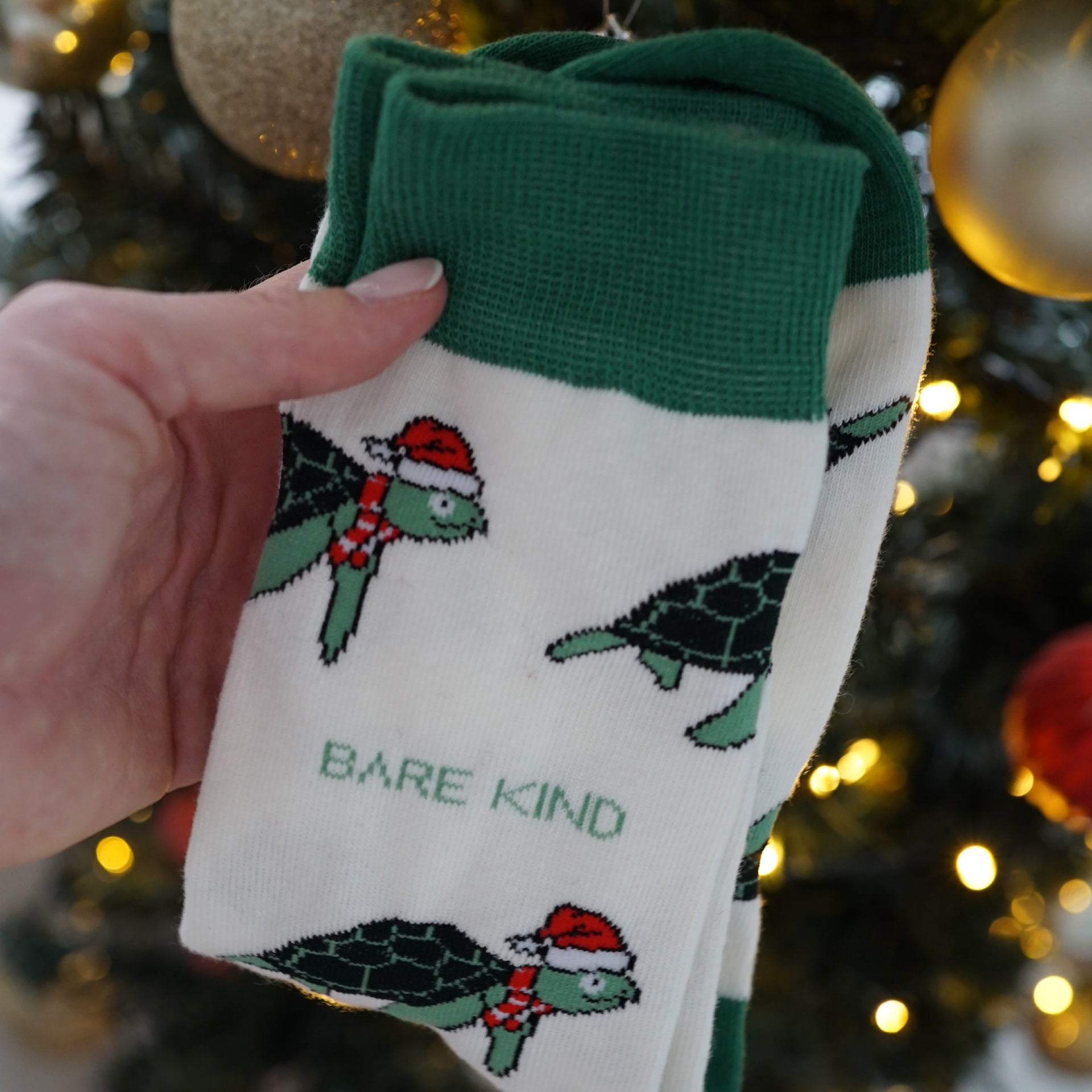 christmas turtle bamboo socks in front of christmas tree