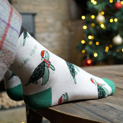 model wearing beige green Christmas turtle bamboo socks