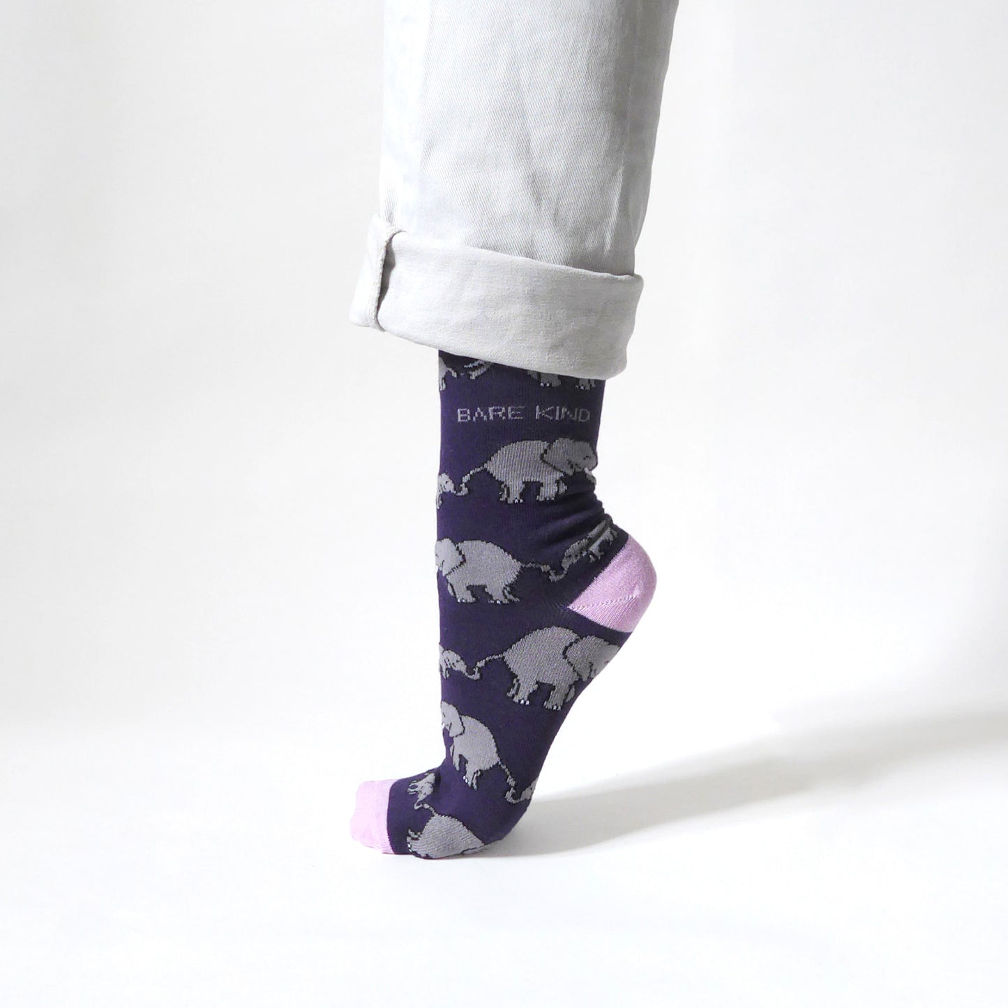 side view of standing model wearing purple and pink elephant bamboo socks