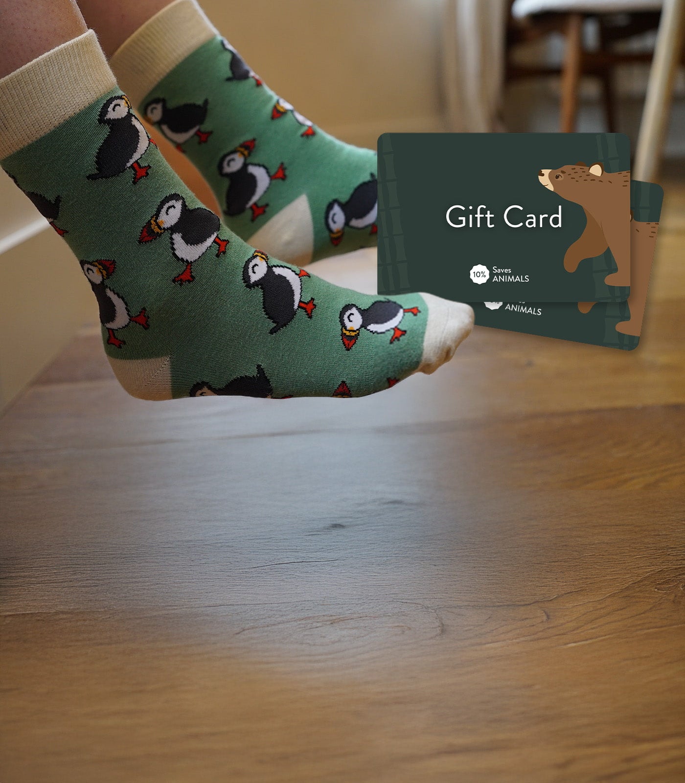 Person wearing green puffins bamboo socks