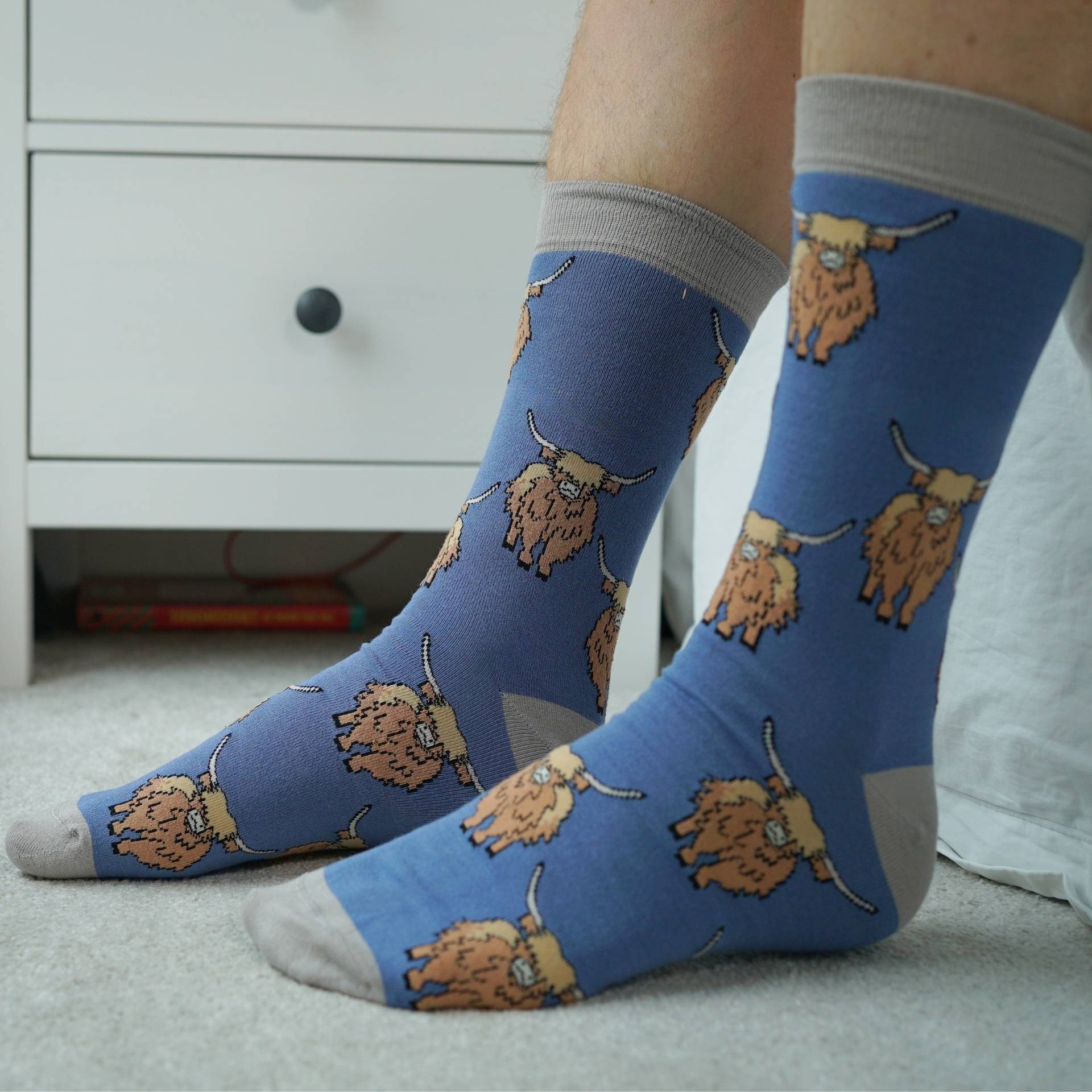 model wearing blue highland cow socks