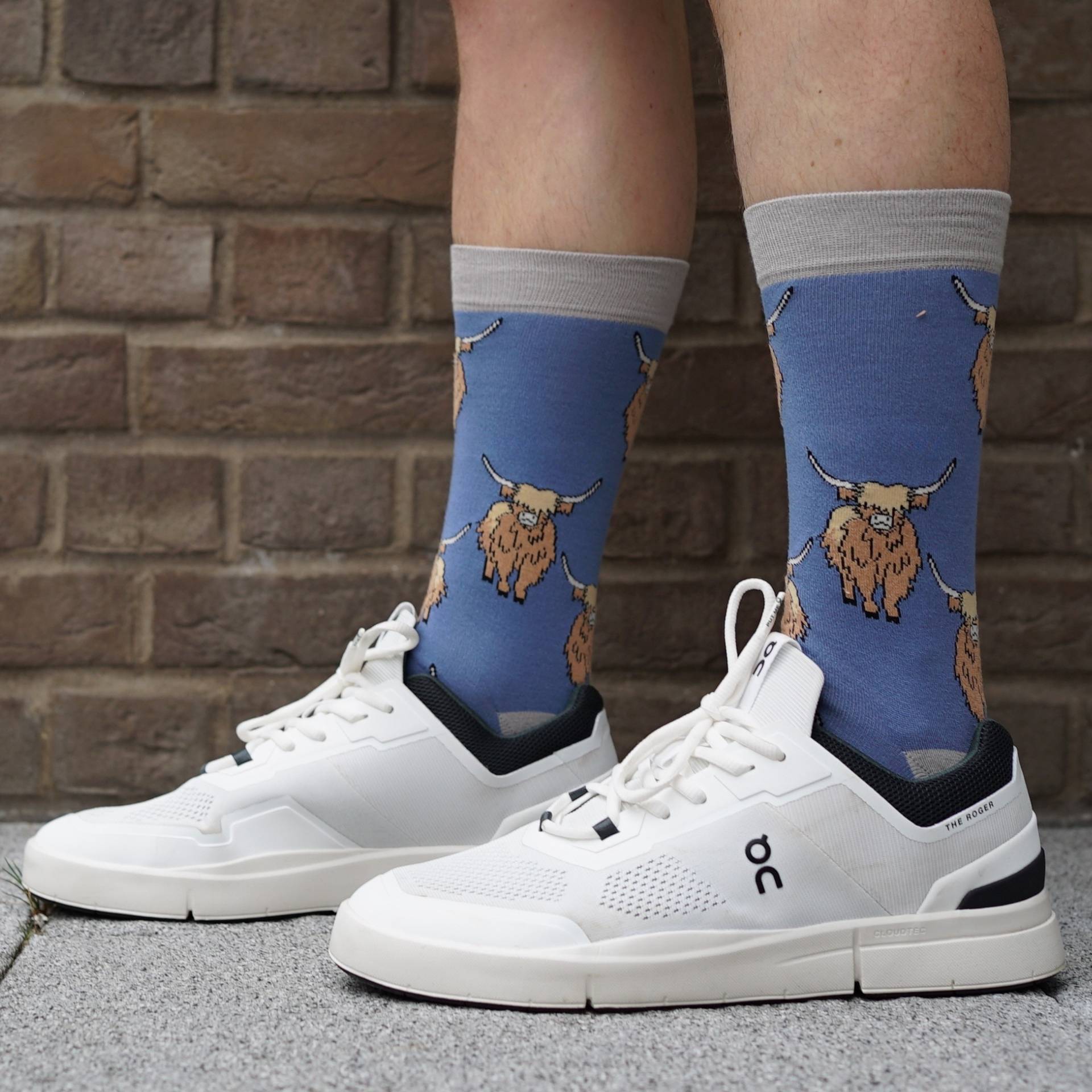 model wearing blue highland cow socks