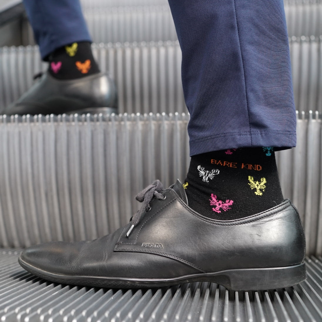 Model wearing Bare Kind bamboo socks, featuring small motifs of lobsters