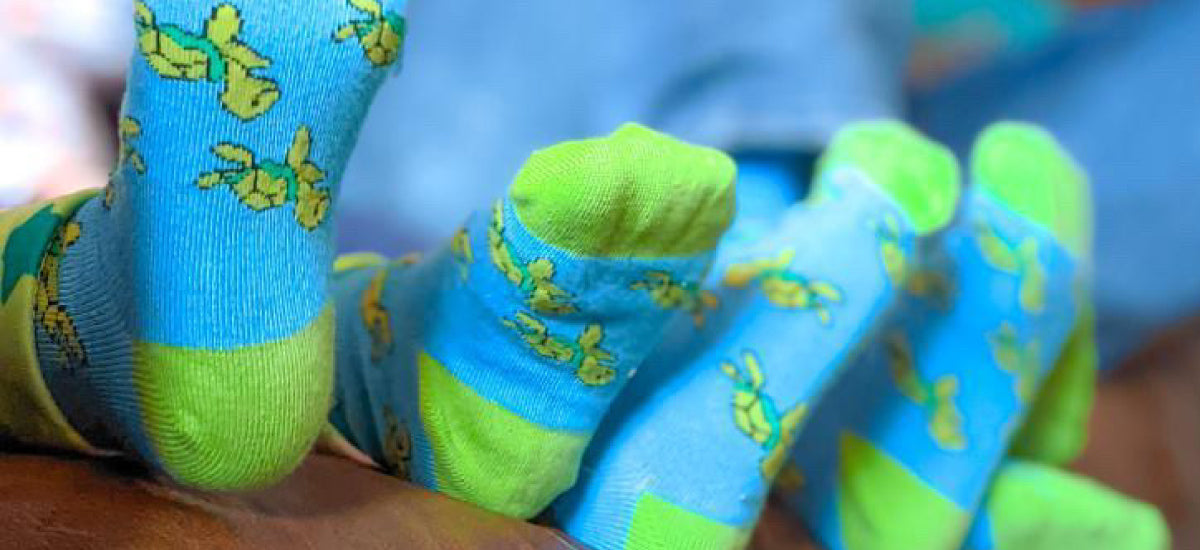 children wearing matching turtle socks