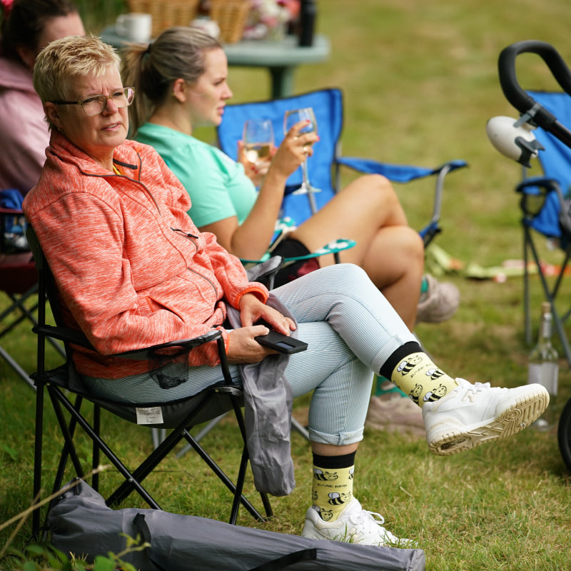 mom wears bee bamboo socks and watching the game