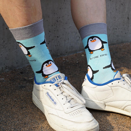 model wearing blue penguin bamboo socks