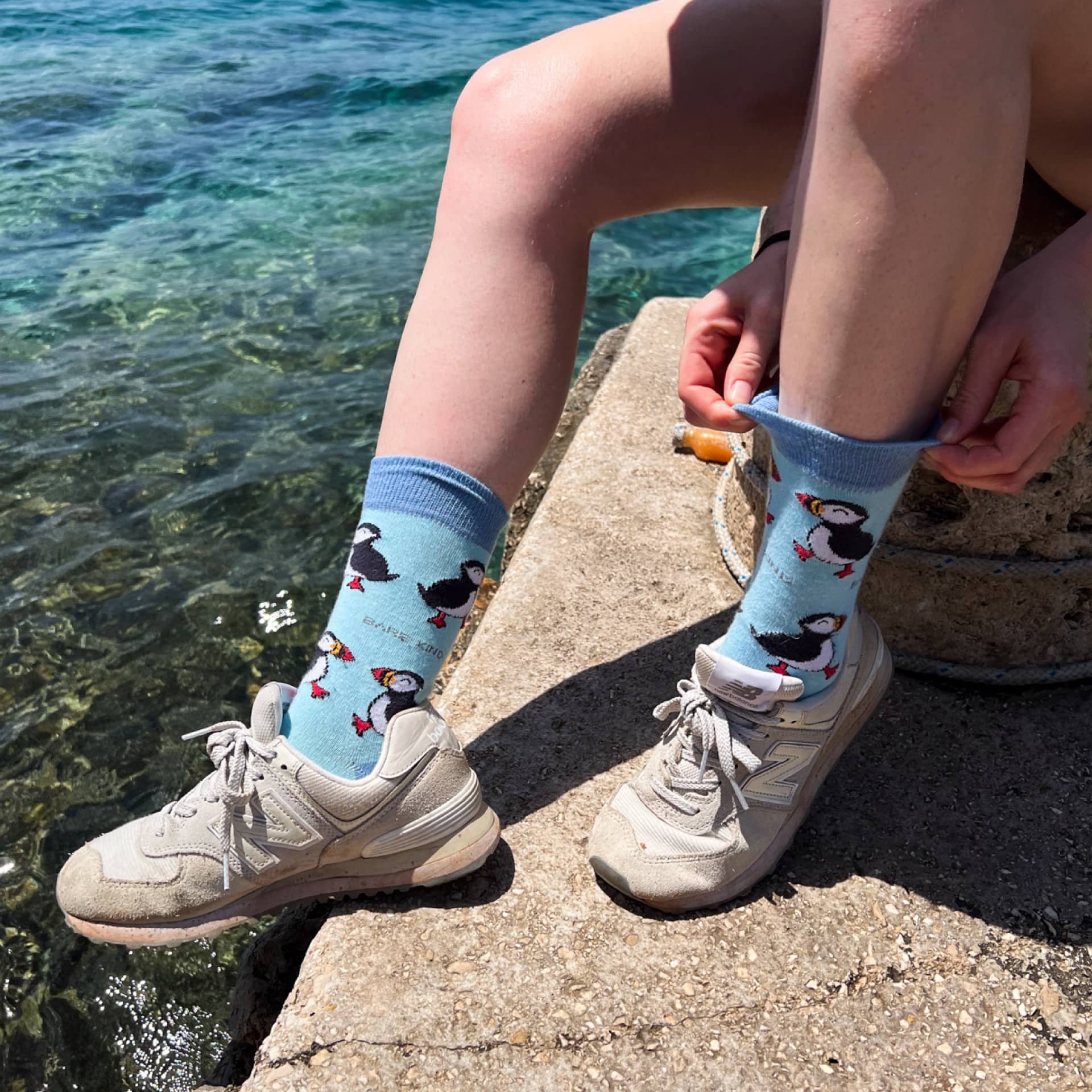 model wearing blue puffin bamboo socks