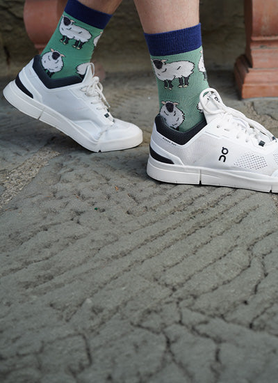 model wearing green sheep bamboo socks