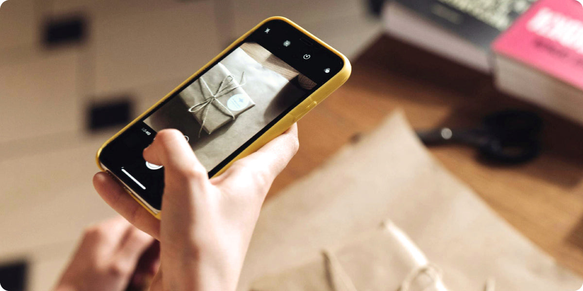 a woman taking photo of eco-friendly gift wrapping