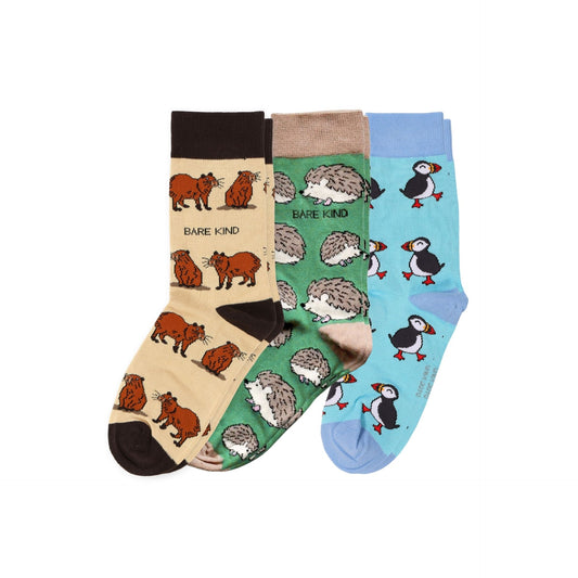 Three pairs of novelty crew socks displayed together on a white background. The left pair is beige with brown wild animals and the text 'BARE KIND'.