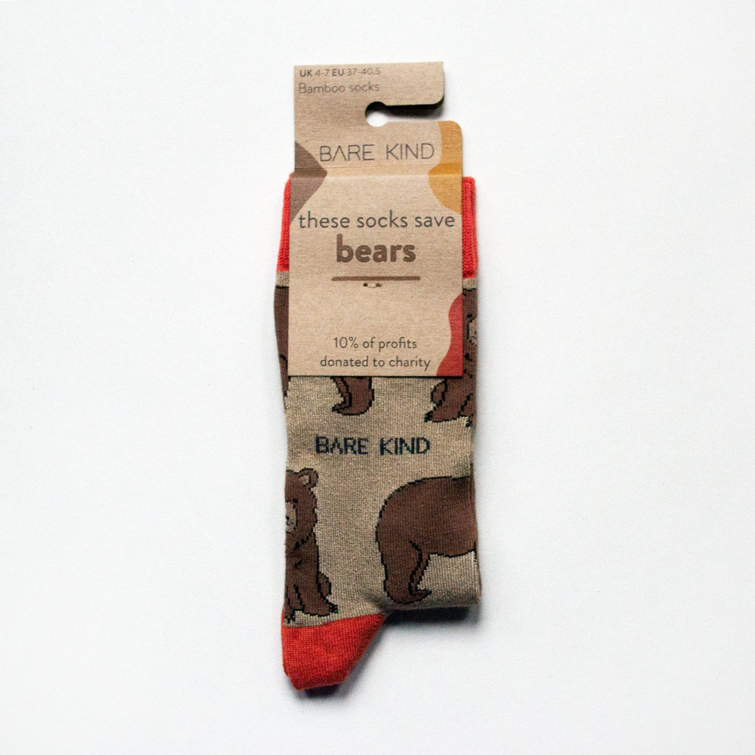 Folded flat lay of brown and red bamboo bear socks wrapped in its 100% recyclable cardboard packaging