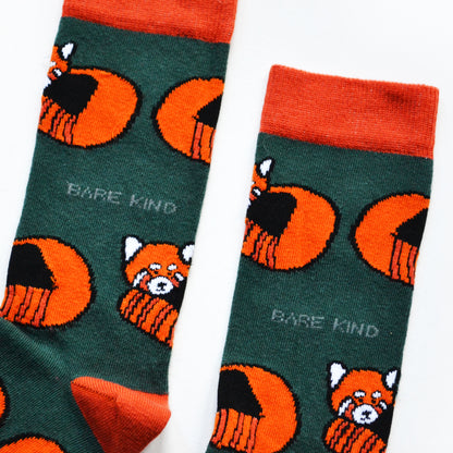 cuff closeup flat lay of dark green bamboo socks with woven red panda design