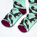 toe closeup flat lay of pastel green otter socks for kids
