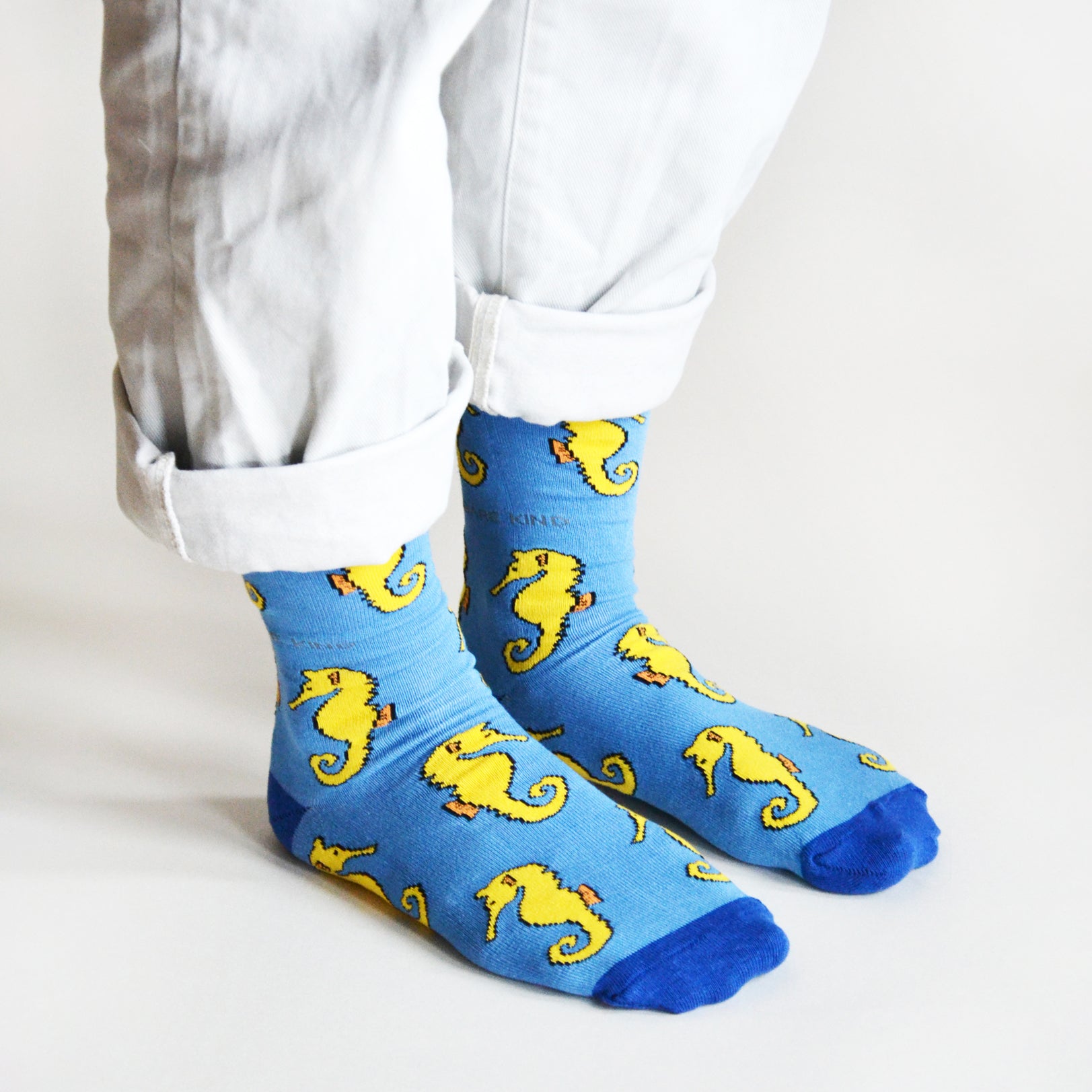 standing model wearing blue seahorse bamboo socks