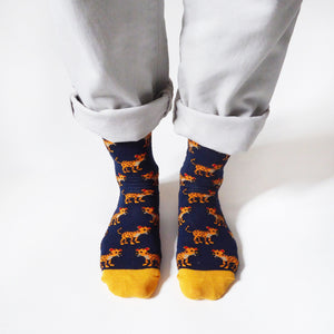 standing model wearing navy blue bamboo socks featuring leopard designs
