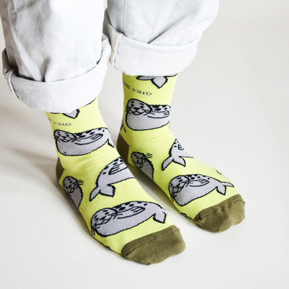 standing model wearing lime green seal socks, side angle birds eye view