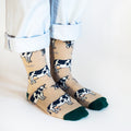 Model side angle view wearing cream and green bamboo cow socks