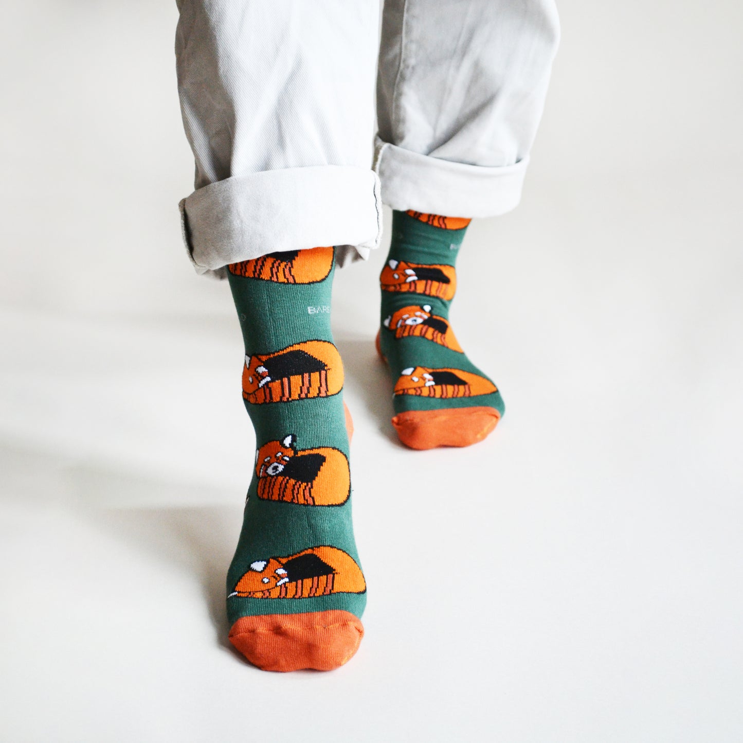 standing model showing red panda sock design