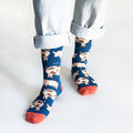 front view of standing model wearing navy blue pig socks, as the right foot is forward