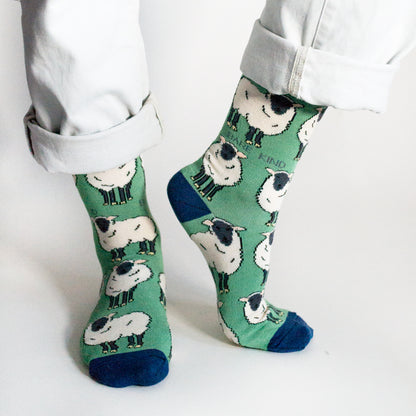 standing model, front view, wearing sheep socks, left heel raised