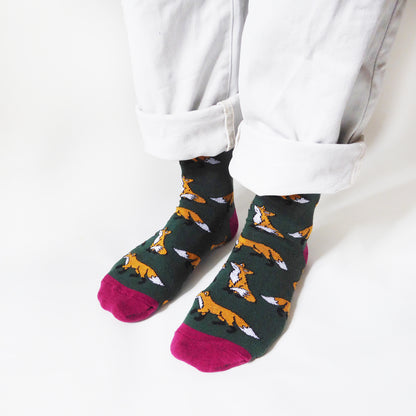 side angle view of standing model wearing dark green fox socks