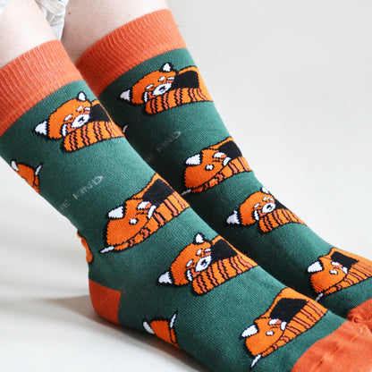 closeup of woven red panda design on dark green bamboo socks