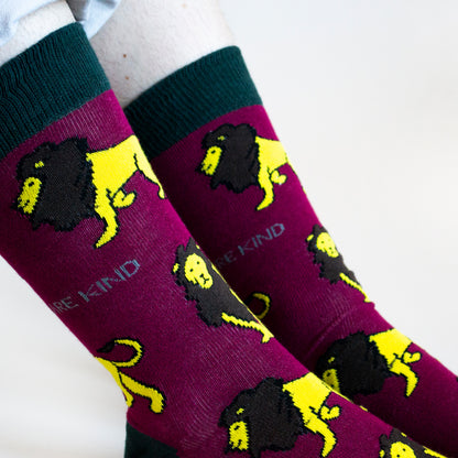 closeup of model wearing burgundy lion socks