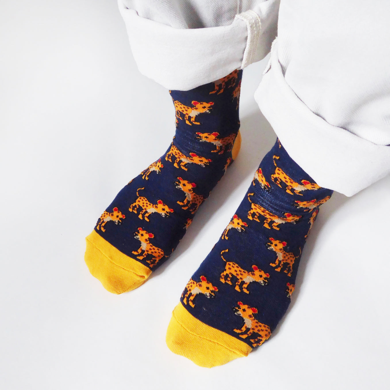 birds eye closeup of model wearing navy blue leopard bamboo socks