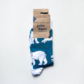 folded flat lay of blue and white polar bear socks in 100% recyclable cardboard packaging