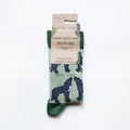 folded flat lay of green bamboo wolf socks in 100% recyclable cardboard packaging